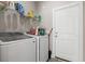 Functional laundry room includes washer, dryer, wire shelving and access to exterior at 10015 W Highway 19, Loris, SC 29569
