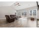 Spacious living room with a vaulted ceiling and a sliding glass door at 10015 W Highway 19, Loris, SC 29569