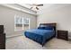 Comfortable main bedroom with large window, ceiling fan, and neutral decor at 10015 W Highway 19, Loris, SC 29569