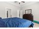 Comfortable main bedroom with large window, ceiling fan, and neutral decor at 10015 W Highway 19, Loris, SC 29569
