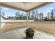 Screened-in patio featuring a ceiling fan, and a fire pit perfect for enjoying the outdoors at 10015 W Highway 19, Loris, SC 29569