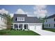 Charming home with light green siding, gray roof, dormer window, and an attached two-car garage at 1071 Laconic Dr., Myrtle Beach, SC 29588