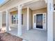 Inviting front porch with white columns, sidelights and craftsman front door with address posted on the column at 1071 Laconic Dr., Myrtle Beach, SC 29588