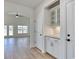 Hallway featuring a built-in bar area with glass cabinets and granite countertops at 1071 Laconic Dr., Myrtle Beach, SC 29588