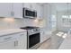 Kitchen with white cabinets, stainless steel appliances, and white backsplash at 1071 Laconic Dr., Myrtle Beach, SC 29588