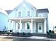 Charming light blue two-story home with a welcoming front porch and white trim on windows at 1083 Milford Way, Myrtle Beach, SC 29588