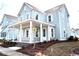 Two-story home with a welcoming front porch framed by white columns and beautiful landscaping at 1083 Milford Way, Myrtle Beach, SC 29588