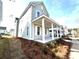 Charming two-story home with inviting front porch, manicured landscaping, and beautiful side view at 1083 Milford Way, Myrtle Beach, SC 29588
