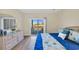 Comfortable bedroom featuring hardwood floors, balcony access with water view, and dresser at 1100 Commons Blvd. # 1001, Myrtle Beach, SC 29572