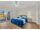 Bedroom with hardwood floors, ceiling fan, balcony access with water view, and a queen-size bed at 1100 Commons Blvd. # 1001, Myrtle Beach, SC 29572