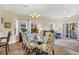 Inviting dining area with glass-top table, upholstered chairs, and a view of the living room at 1100 Commons Blvd. # 1001, Myrtle Beach, SC 29572