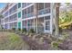 Well-maintained building exterior with lush landscaping and inviting screened porches at 1100 Commons Blvd. # 1001, Myrtle Beach, SC 29572