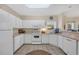 Bright kitchen featuring white appliances, ample counter space, tile floors, and a window at 1100 Commons Blvd. # 1001, Myrtle Beach, SC 29572