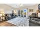 Comfortable living room featuring hardwood floors, neutral walls, a ceiling fan, and balcony access at 1100 Commons Blvd. # 1001, Myrtle Beach, SC 29572