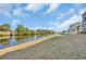Scenic waterfront view with calm water, lush trees, and manicured lawn near the condo buildings at 1100 Commons Blvd. # 1001, Myrtle Beach, SC 29572