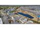 Aerial view of neighborhood featuring golf course, tennis courts, and lake at 1100 Possum Trot Rd. # C202, North Myrtle Beach, SC 29582