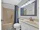 Bright bathroom with neutral-toned vanity, toilet, and bathtub-shower combo at 1100 Possum Trot Rd. # C202, North Myrtle Beach, SC 29582