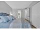 Comfortable bedroom with queen bed, light grey walls, wood-look floors, and bathroom access at 1100 Possum Trot Rd. # C202, North Myrtle Beach, SC 29582