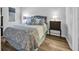 Comfortable bedroom featuring a queen bed, wood-look floors, and natural light at 1100 Possum Trot Rd. # C202, North Myrtle Beach, SC 29582