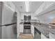 Modern kitchen with stainless steel appliances, granite countertops, and white cabinets at 1100 Possum Trot Rd. # C202, North Myrtle Beach, SC 29582