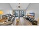 Bright living room with sliding glass doors to patio and stylish leather sofa at 1100 Possum Trot Rd. # C202, North Myrtle Beach, SC 29582