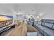 Spacious open-plan living area flowing into the kitchen with modern furnishings at 1100 Possum Trot Rd. # C202, North Myrtle Beach, SC 29582