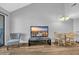 Living room with a mounted TV, comfortable chair, and small dining table at 1100 Possum Trot Rd. # C202, North Myrtle Beach, SC 29582