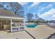 Community pool with outdoor seating and covered patio area at 1100 Possum Trot Rd. # C202, North Myrtle Beach, SC 29582