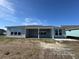 Back view of the house with patio and multiple windows at 1105 Oxeye St., North Myrtle Beach, SC 29582