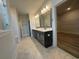 Spacious bathroom with double vanity, marble countertops, and walk-in closet at 1105 Oxeye St., North Myrtle Beach, SC 29582