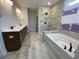 Bathroom boasts double vanity, tiled floors, and a separate tub and tiled shower with niche at 1105 Oxeye St., North Myrtle Beach, SC 29582