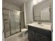 Bathroom featuring a shower with glass door, tiled walls, vanity with sink, and modern fixtures at 1105 Oxeye St., North Myrtle Beach, SC 29582