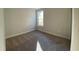 A small, carpeted bedroom with neutral walls and a single window casting shadows on the floor at 1105 Oxeye St., North Myrtle Beach, SC 29582