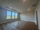 Bright bedroom featuring tray ceilings and large windows at 1105 Oxeye St., North Myrtle Beach, SC 29582