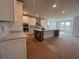 Bright kitchen features large island, white cabinetry, and lots of natural light at 1105 Oxeye St., North Myrtle Beach, SC 29582