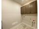 Bright laundry area featuring overhead cabinets and washer/dryer hookups at 1105 Oxeye St., North Myrtle Beach, SC 29582