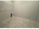 Clean laundry room featuring a tiled floor and hookups for a washer and dryer at 1105 Oxeye St., North Myrtle Beach, SC 29582