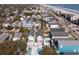 Aerial view showcasing homes with swimming pools and lush greenery near the beachside community at 113-B 10Th Ave. S, Surfside Beach, SC 29575