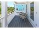 Cozy balcony area features two chairs, a table and views of the neighborhood at 113-B 10Th Ave. S, Surfside Beach, SC 29575