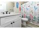 Colorful bathroom featuring a vanity with modern fixtures and a fun, beach-themed shower curtain at 113-B 10Th Ave. S, Surfside Beach, SC 29575