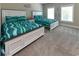 Shared bedroom features two beds with bright colored bedding, large windows, and carpeted floors at 113-B 10Th Ave. S, Surfside Beach, SC 29575