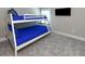 Bedroom with white bunk beds with blue linens and a neutral carpet at 113-B 10Th Ave. S, Surfside Beach, SC 29575