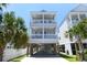 Stunning three-story beach house with covered parking and dual balconies providing ocean views at 113-B 10Th Ave. S, Surfside Beach, SC 29575