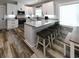 Bright kitchen boasts a breakfast bar, granite countertops, and stainless steel appliances at 113-B 10Th Ave. S, Surfside Beach, SC 29575