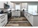 Modern kitchen featuring white cabinets, granite countertops, and stainless steel appliances at 113-B 10Th Ave. S, Surfside Beach, SC 29575