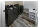 This laundry room features a modern washer and dryer with faux-wood floors at 113-B 10Th Ave. S, Surfside Beach, SC 29575