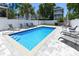 Backyard pool featuring lounge chairs and a concrete tile surround, enclosed by a white fence at 113-B 10Th Ave. S, Surfside Beach, SC 29575