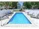 Backyard pool with a concrete tile surround and a metal railing, enclosed by a white fence at 113-B 10Th Ave. S, Surfside Beach, SC 29575