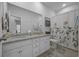 Bright bathroom boasts double sinks, granite countertops, and a decorative shower curtain at 1201 Ficus Dr., Myrtle Beach, SC 29579