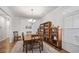 Cozy dining room featuring natural light, chandelier, wooden table, and shelving for decorative items or book storage at 1201 Ficus Dr., Myrtle Beach, SC 29579